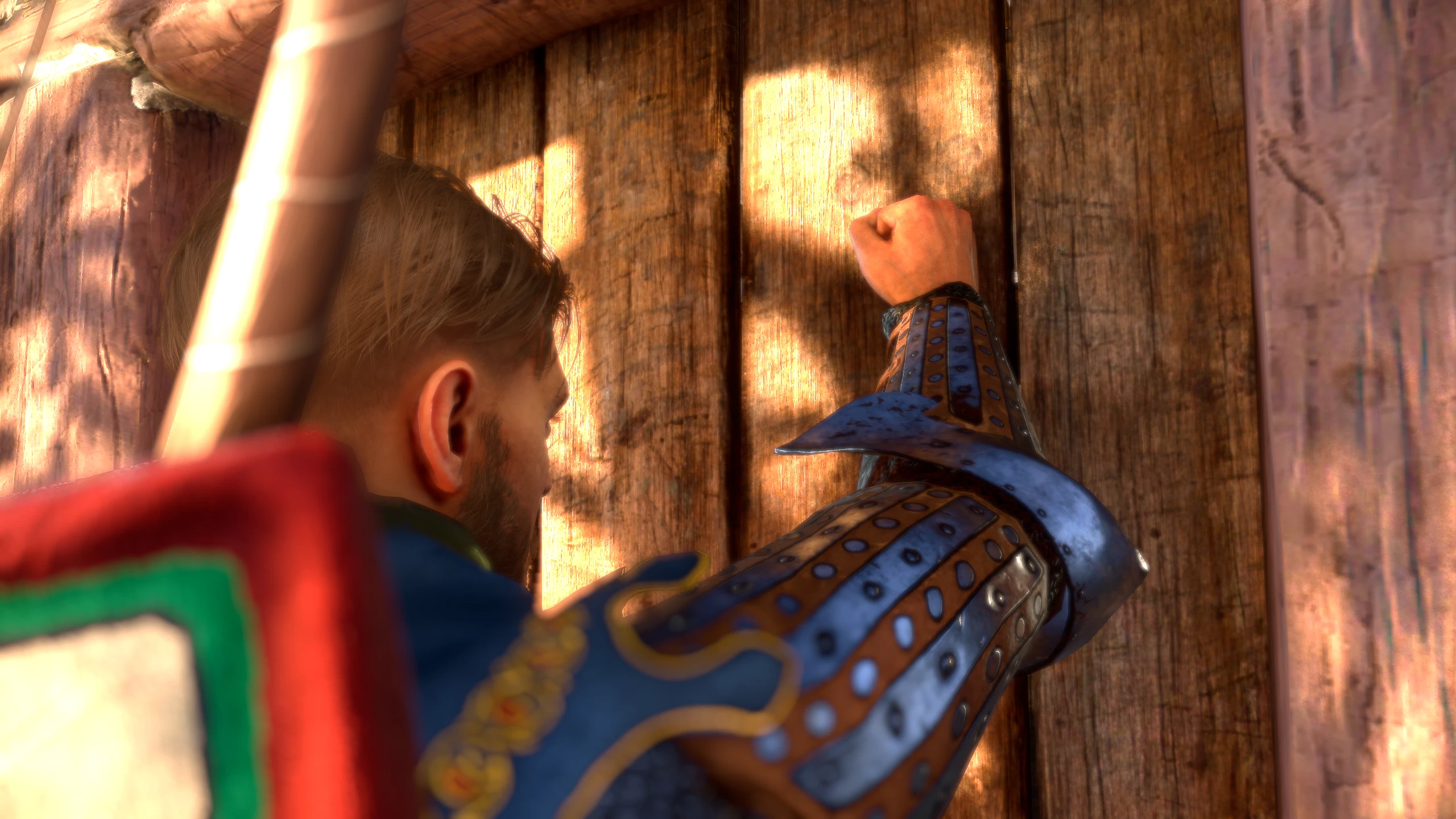 Henry raises his armored arm to knock on a sunlit wooden door.