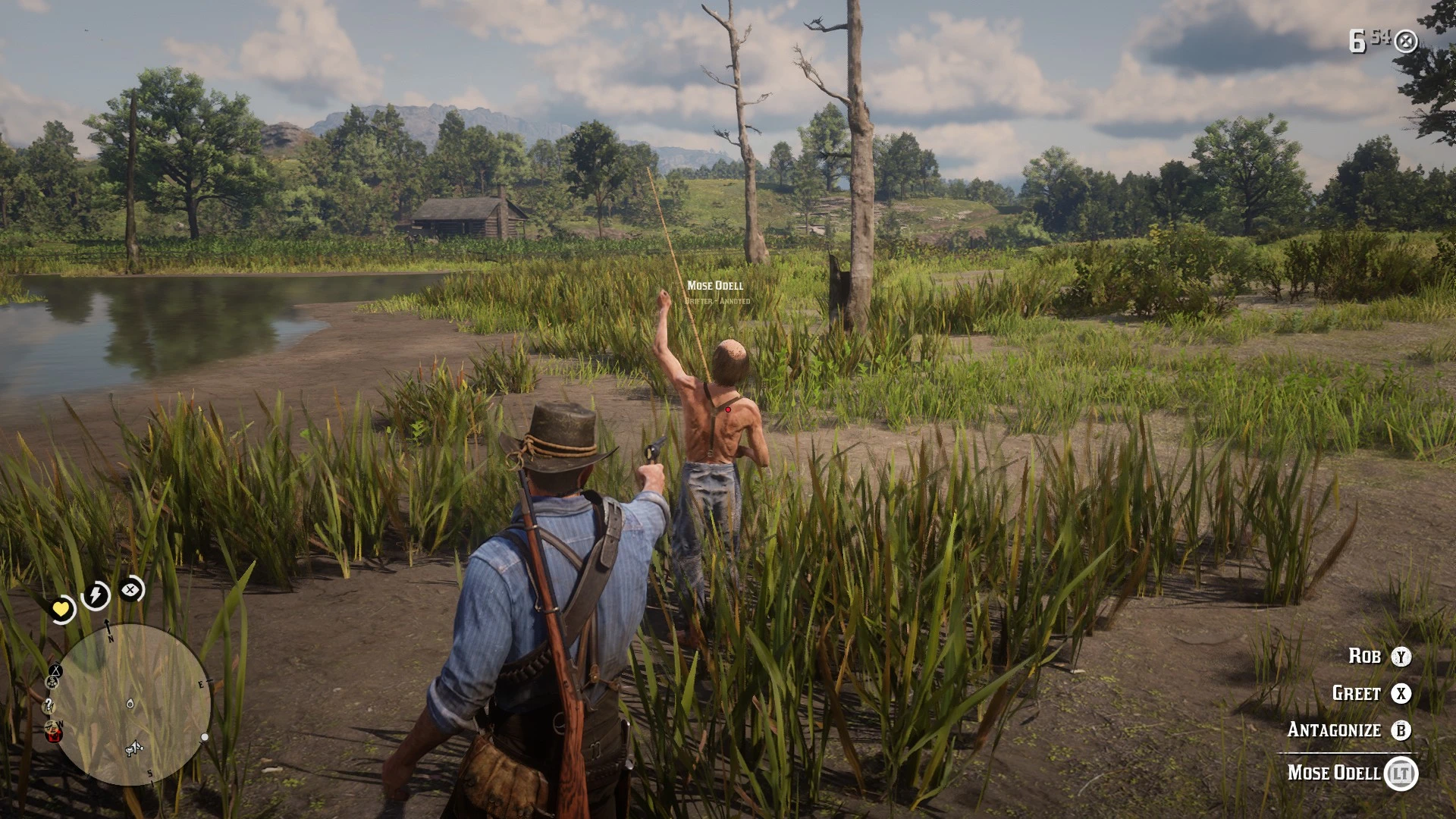 Arthur aims a revolver at a named stranger with one hand raised beside a marsh in Red Dead Redemption 2.