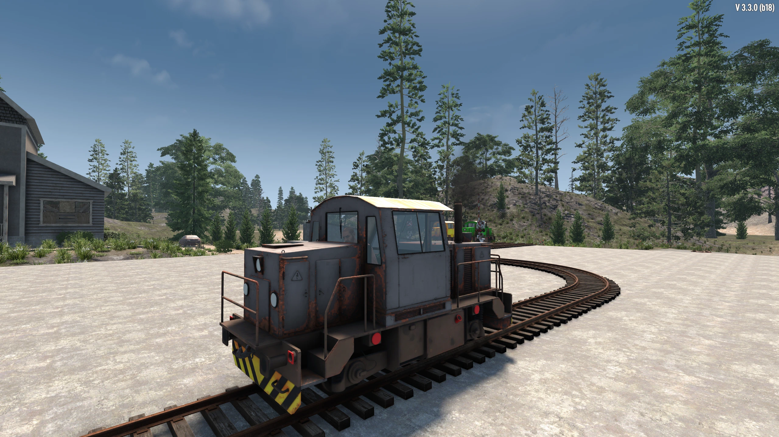 A gray diesel shunting locomotive sits on a curved player-built railway in 7 Days to Die.