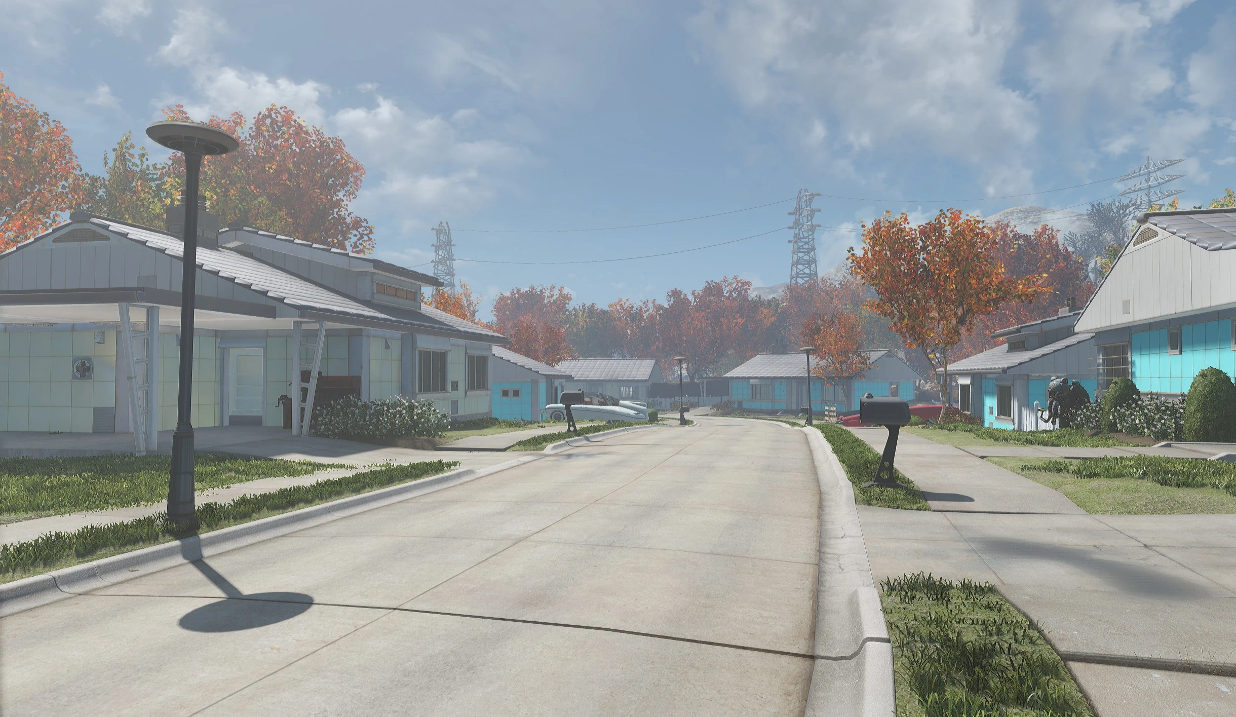 Restored blue and white houses line a clean Sanctuary Hills road beneath autumn trees and a cloudy sky.