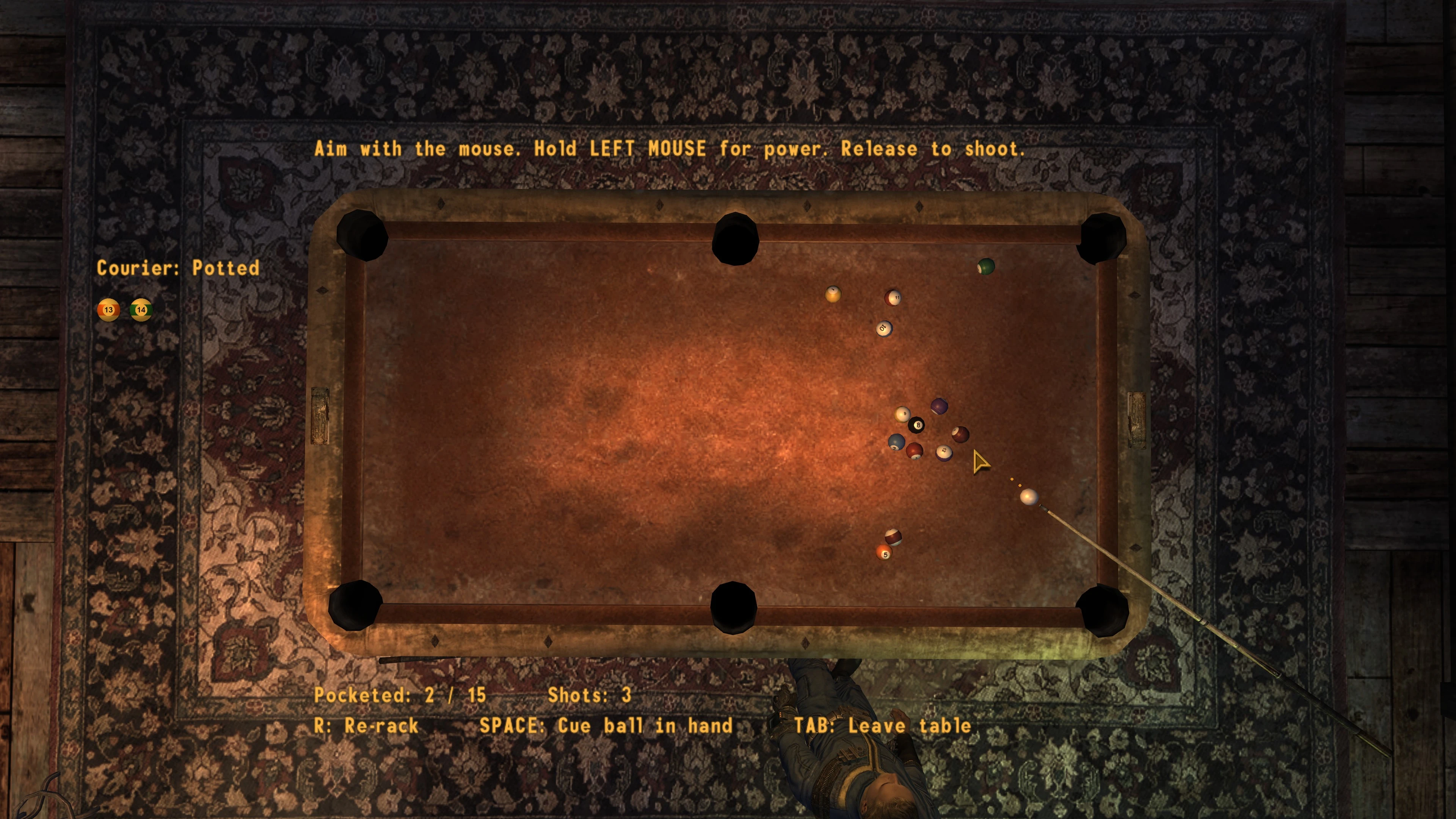An overhead view of a worn pool table in Fallout: New Vegas, with a cue aimed at the white ball and scattered colored balls.