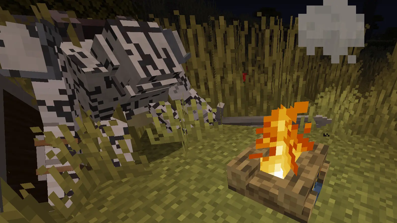 A large Late Game Golems companion standing beside a campfire at night.