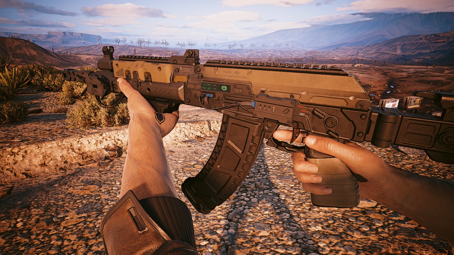 First-person view of the tan Polaris experimental rifle overlooking Cyberpunk 2077’s Badlands.