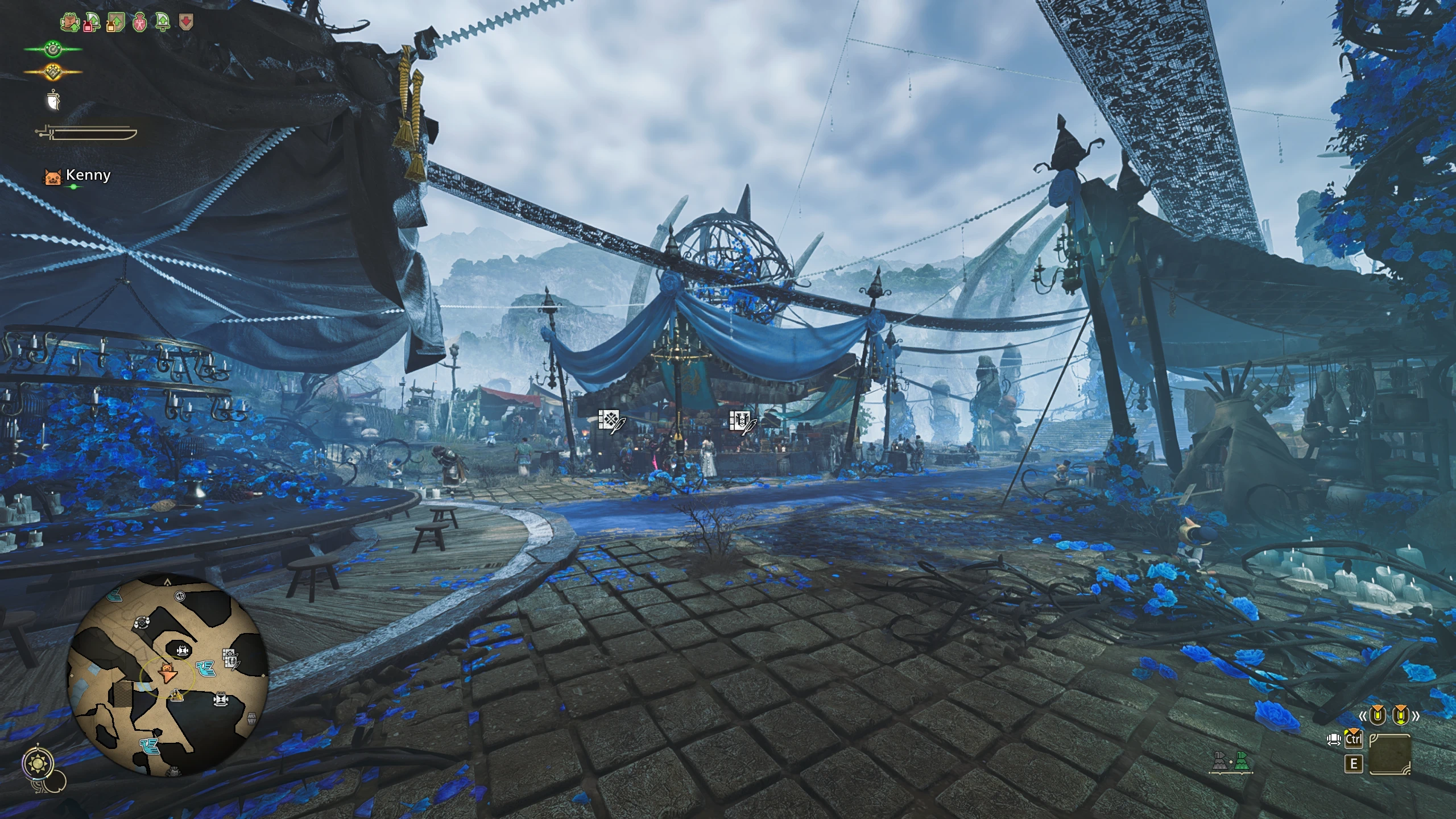 An eye-level view looks along a blue-flower-lined settlement walkway toward a central market canopy.