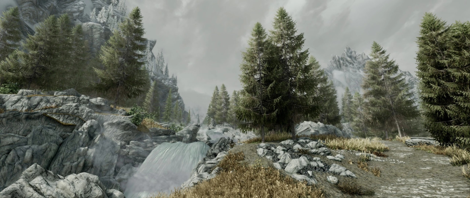 Tall conifers frame a rocky stream and mountain path in Skyrim’s Nordskog tree overhaul.