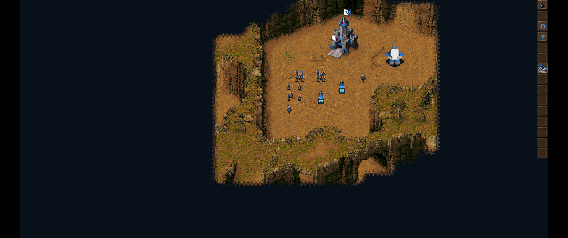 Blue units and a base occupy a revealed plateau surrounded by dark unexplored terrain in KKND Xtreme.