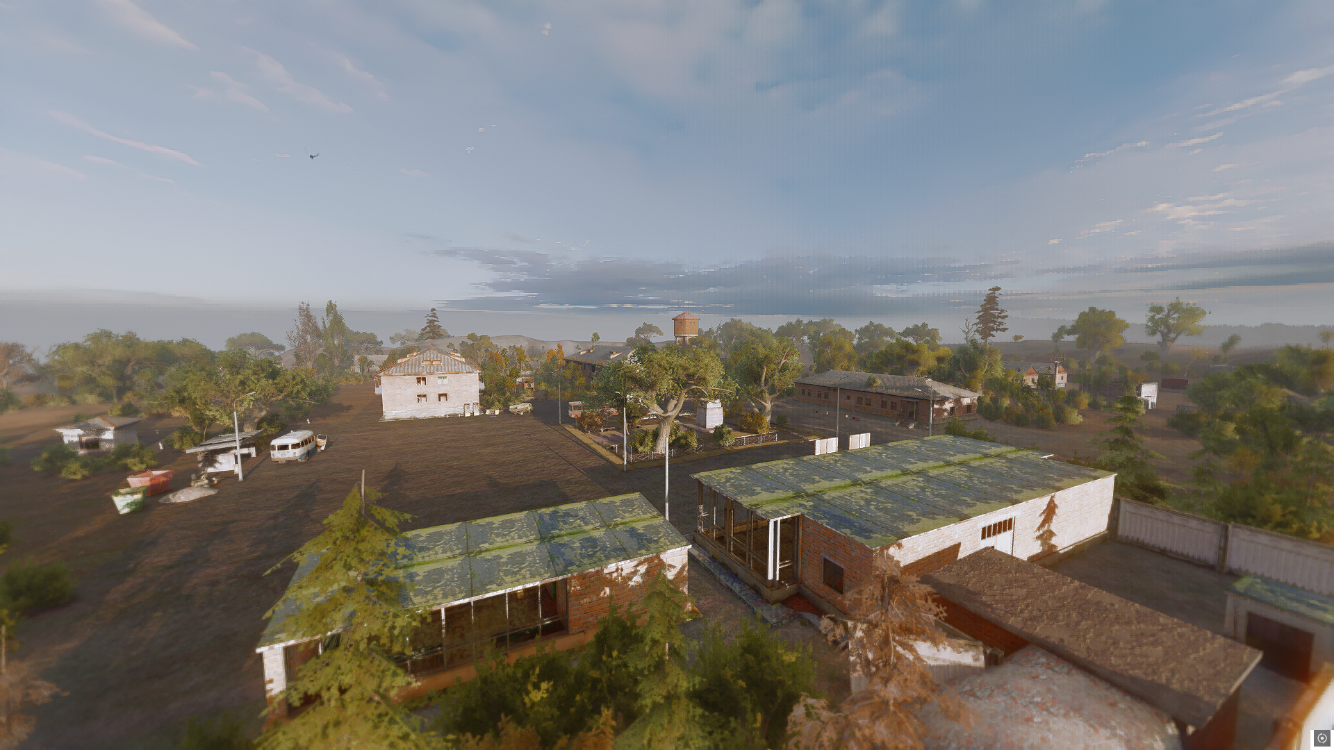 An elevated view of the added Dead City district, with weathered buildings, trees and a water tower.