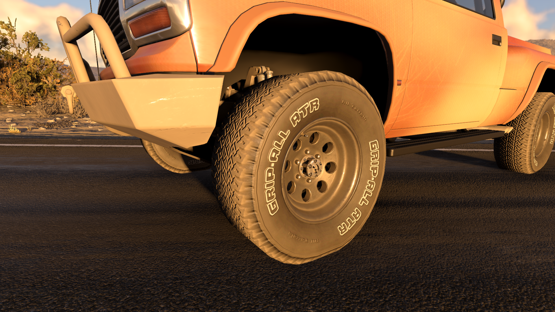 Close-up of an orange Gavril D-Series with dust covering its front tire, wheel and lower bodywork.